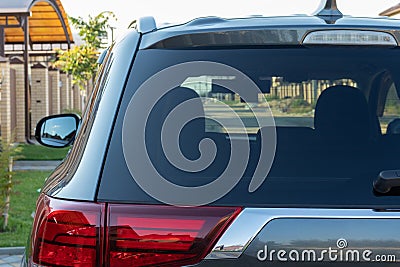 Car parked on the street in residential district, back view. Mock up of rear window for sticker or decals Stock Photo