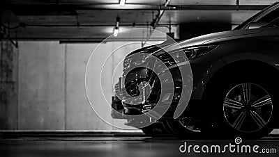 Car parking in shopping mall underground parking lot. Indoor car parking. Black and white scene of car parked at basement Stock Photo