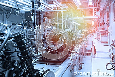 Car parts on production line. Factory for production of cars in blue. Modern automotive industry. Blue tone Stock Photo