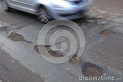 Car passing big potholes Stock Photo