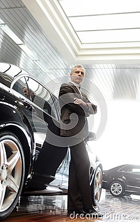 This car is perfect for me. Confident senior businessman leaning Stock Photo