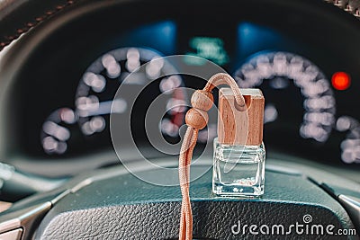 Car perfume or air freshener on the steering wheel and blurred dashboard lights in the background Stock Photo