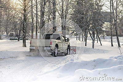 Car pickup cleaned from snow by a snowplough during wintertime Stock Photo