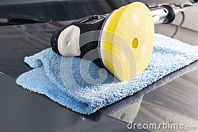 Car polish concept. Buffing and polishing car. Car detailing. Polisher and microfiber cloth on the car. Tools for polishing Stock Photo