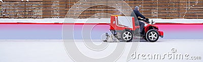 The car for polishing the ice surface of the ice rink for winter entertainment rides and restores the ice Editorial Stock Photo