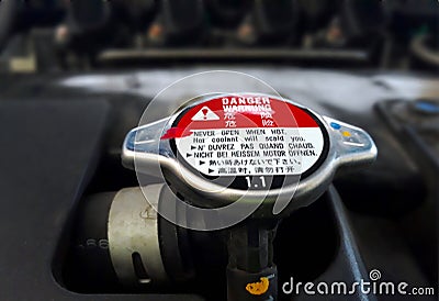 Car radiator cap with warning sign Stock Photo