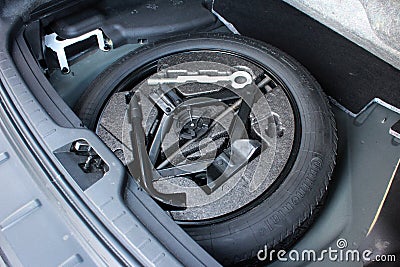 Car Repair kit and jack in trunk. Car spare wheel in trunk. Editorial Stock Photo