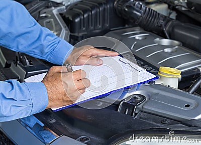 Car repair service, Auto mechanic checking car engine Stock Photo