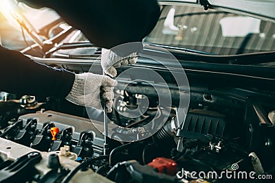 Car Repair service, Auto mechanic working in garage, Mechanic hands checking up of serviceability of the car in open hood, close Stock Photo