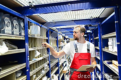 Car repair shop employees in the warehouse for spare parts for r Stock Photo