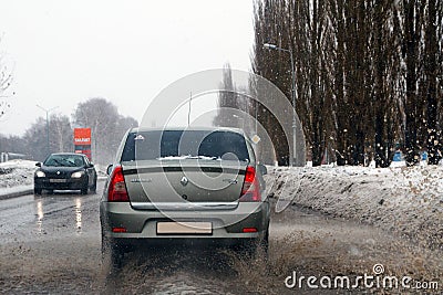 Salavat, Russia - February 26, 2017: car rides on dirty puddle with splashes Editorial Stock Photo