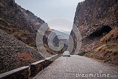 Car on a road way to an important natural attraction of Armenia - a Symphony of Stones or basalt Pillars Stock Photo