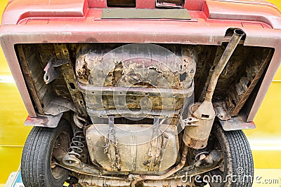 Car with rusty, damaged, corroded undercarriage at workshop for Stock Photo