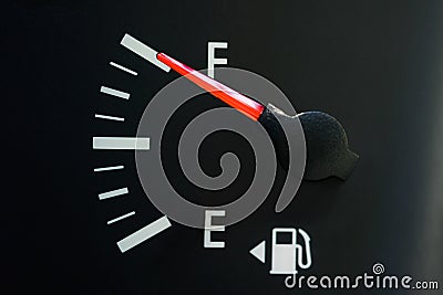 The car`s fuel gauge shows a full, close-up, rough black panel. Stock Photo