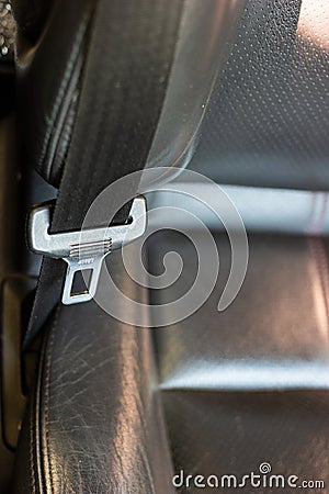 Car safety belt mechanism top view shallow depth of field dark leather seats Stock Photo