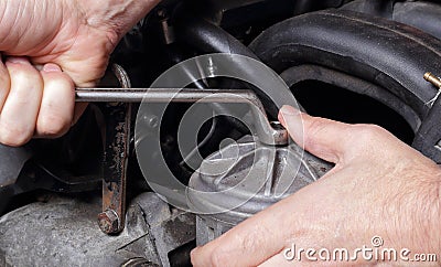 Car service - Engine repair hand with wrench fuel filter Stock Photo