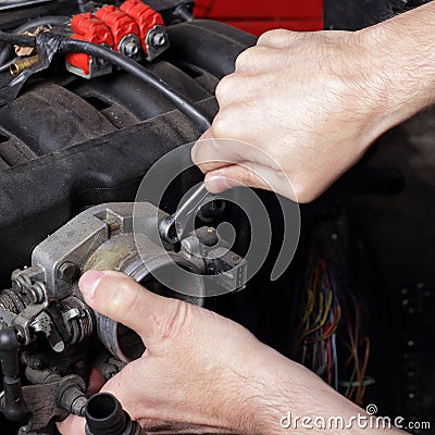 Car service - Engine repair mechanic hand with wrench Stock Photo