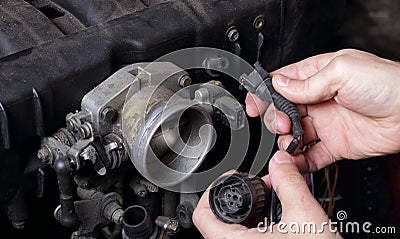 Car service - Engine repair mechanic hands wiring terminal Stock Photo