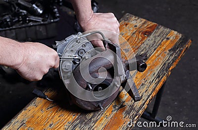 Car service - Engine repair mechanic hands with wrench Centrifugal compressor nut Stock Photo