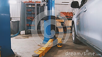 Car service - white vehicle in workshop for repairing or checking Stock Photo