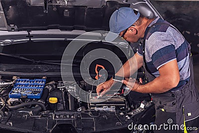Car service worker diagnoses car breakdown Stock Photo