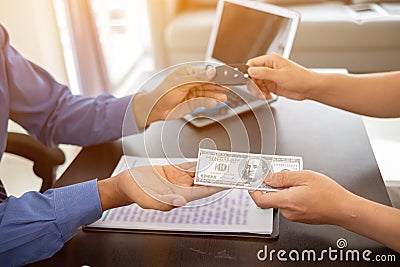 The car showroom car dealer handed over the keys to the customer after the purchase contract was finalized. The concept of buying Stock Photo