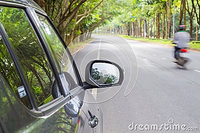 Car standing on wayside of the road with green tunel forest road Stock Photo