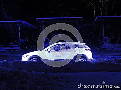 Car Stay On A Snowy Road Kerb At Winter Night Stock Photo