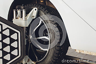 A Car on the Car Steering Wheel Balancer and Calibrate with laser reflector attach on each tire to center driving adjust Stock Photo