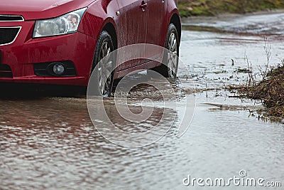 Car stuck in the mud car wheel in dirty puddle rough terrain Stock Photo
