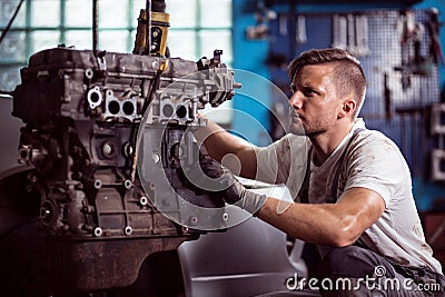 Car technician maintaining automotive engine Stock Photo