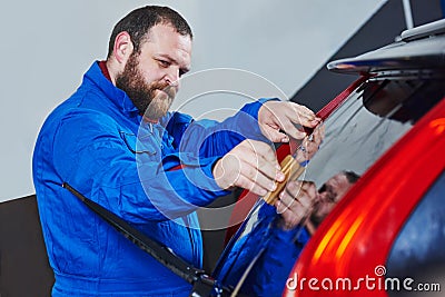 Car tinting. Automobile mechanic technician applying foil Stock Photo