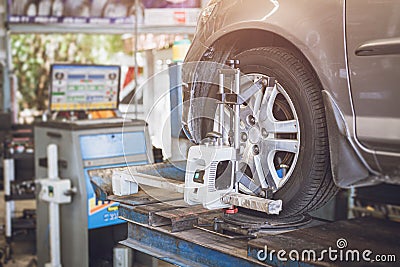 Car tire steering wheel balancing calibrate device for center adjust after tyre replace at garage Stock Photo