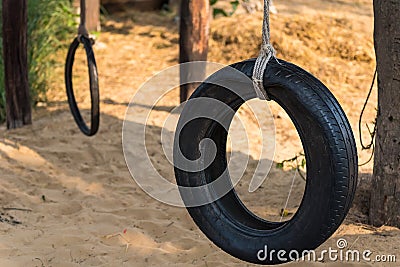 Car tire used as a swing on a tree in the garden. Concept photo of childhood, nostalgia, memory , past, life, retro, vintage, home Stock Photo