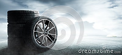 Car tires on a wet foggy road Stock Photo