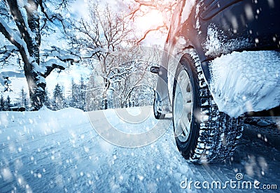 Car tires on winter road Stock Photo