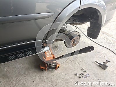 Car to remove the wheel for maintenance with body lift equipment. Stock Photo