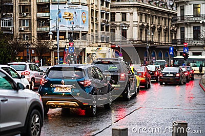 Car traffic at rush hour on the main boulevard in Bucharest downtown. Rainy morning, rainy evening during winter in Bucharest, Editorial Stock Photo