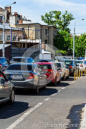 Car traffic at rush hour stopped at red light. Car pollution, traffic jam in the morning and evening in the capital city of Editorial Stock Photo