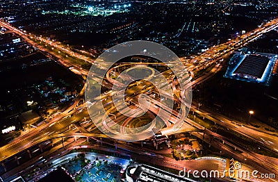 Car traffic transport on multiple lane highway or winding road expressway in Asia city at night, drone aerial view Stock Photo