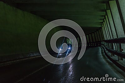 Car tunnel in the Alps with oncoming traffic, Austria Stock Photo