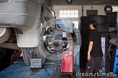 Car tyre alignment wheel balance at garage service workshop. Stock Photo