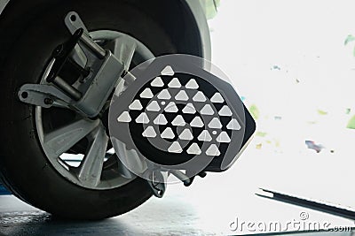 car tyre clamped with aligner reflector adjustment tool for whe Stock Photo