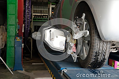 car tyre clamped with aligner reflector adjustment tool for whe Stock Photo