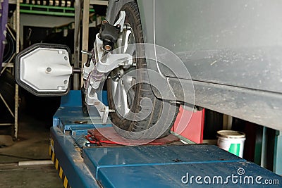 car tyre clamped with aligner reflector adjustment tool for whe Stock Photo