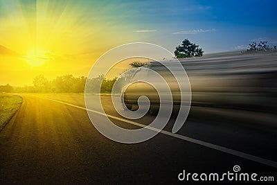 Car very fast speed on the road in the evening and beams sunset. Using idea background automotive concept. Stock Photo