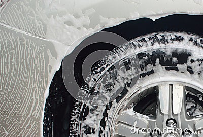 Car wash foam cleaning carbody and tire Stock Photo