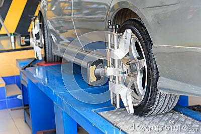 Car Wheel Alignment in tire garage Stock Photo