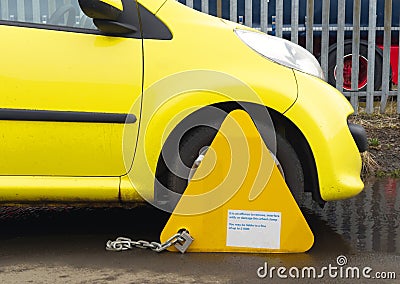Car wheel clamped at restricted parking area Stock Photo
