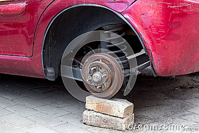 Car without wheels costs on brick. Stock Photo